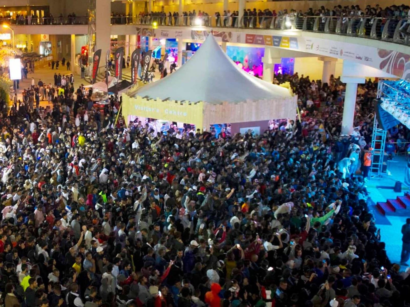An aerial view of a large night-time crowd at the Bahrain Noor El Ain festival